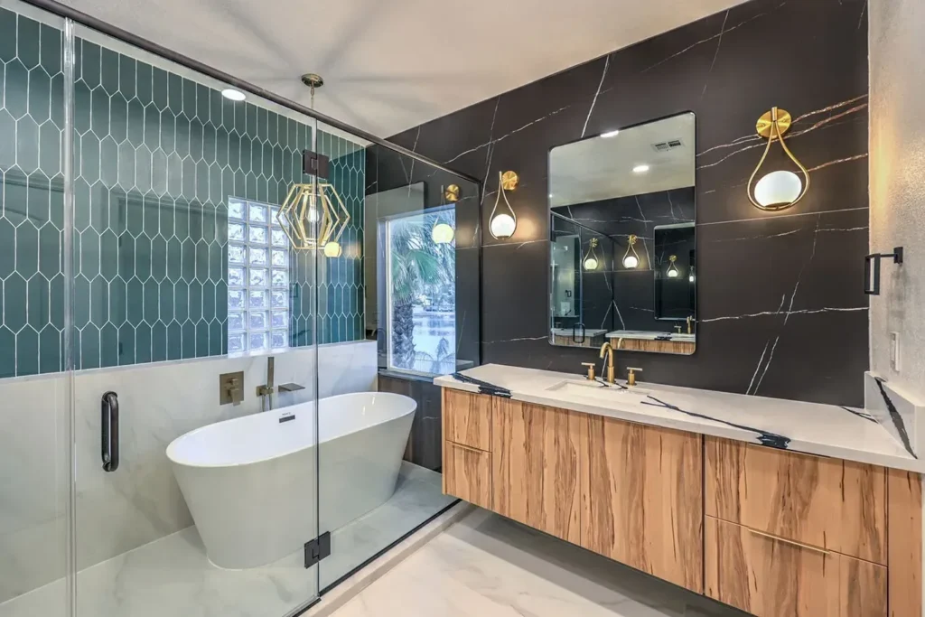 Finished bathroom remodel with a freestanding tub and tiled feature wall