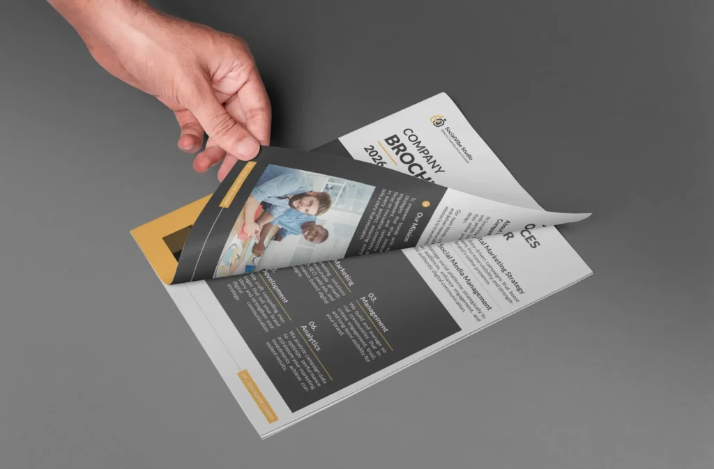 Hand holding a printed trifold brochure design