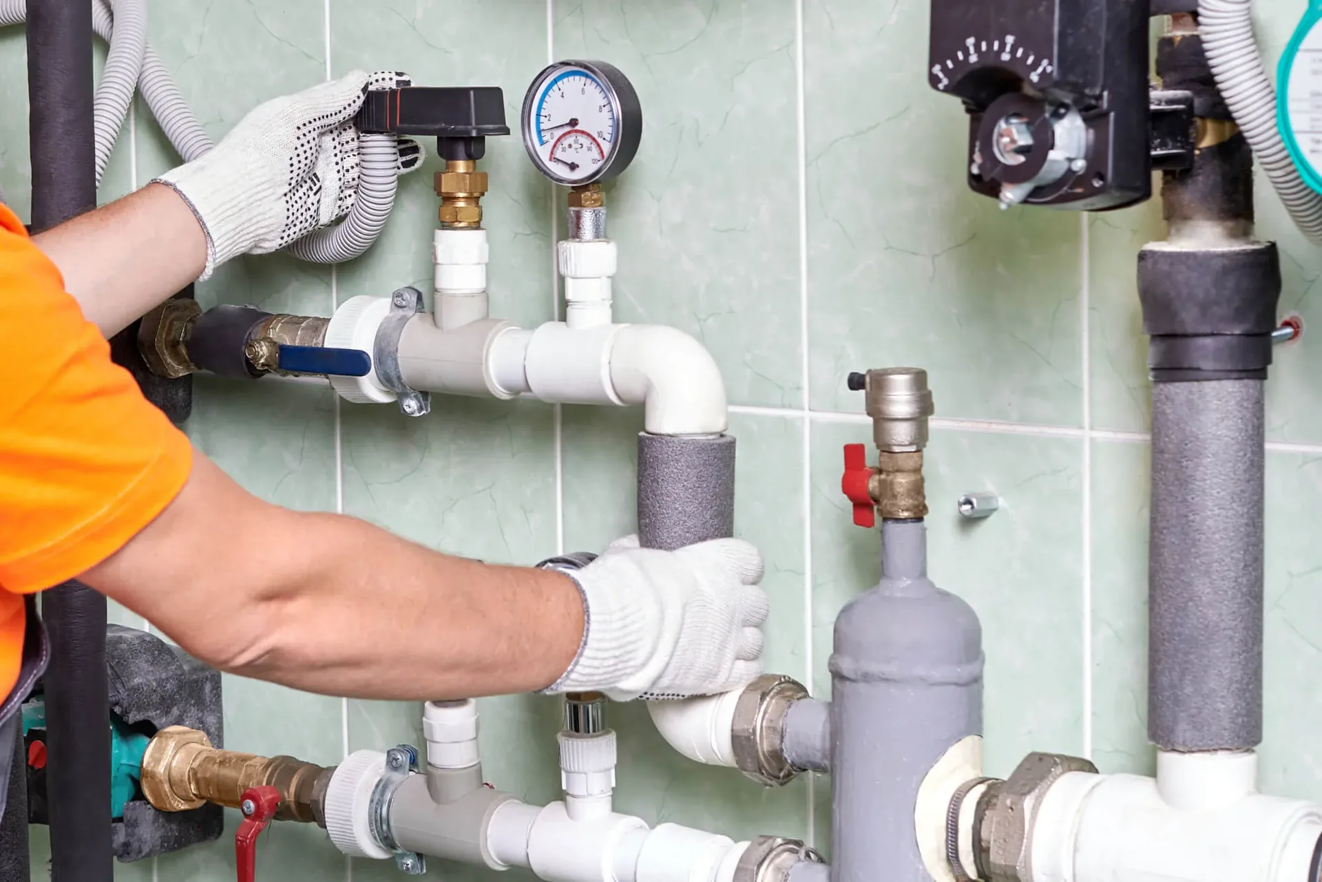 Plumbing manifold with pressure gauge and copper pipework