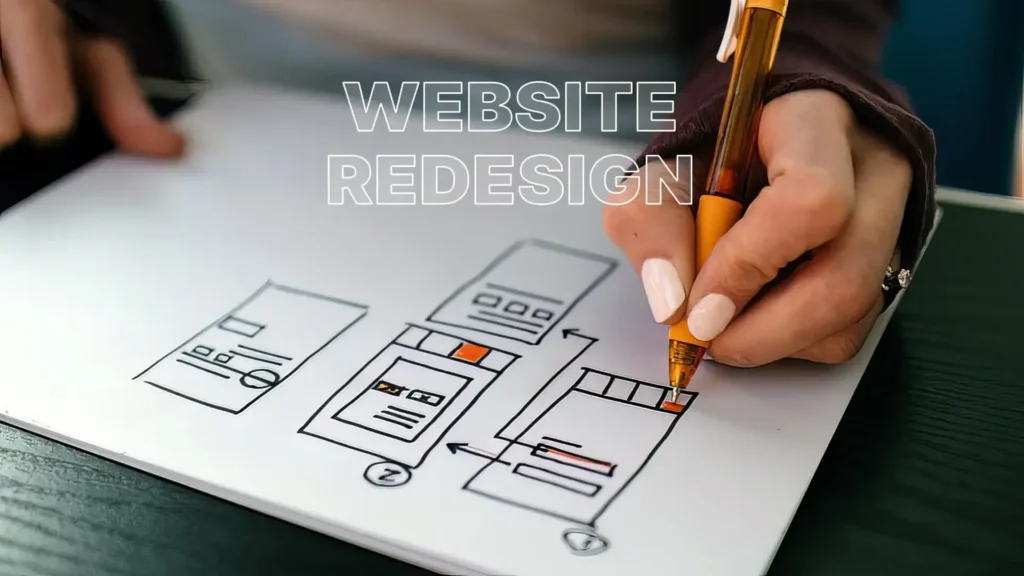 Designer sketching a website redesign wireframe on paper