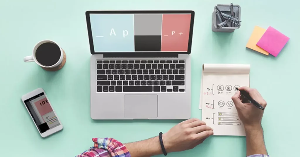 Laptop and colour swatches used to plan a website redesign