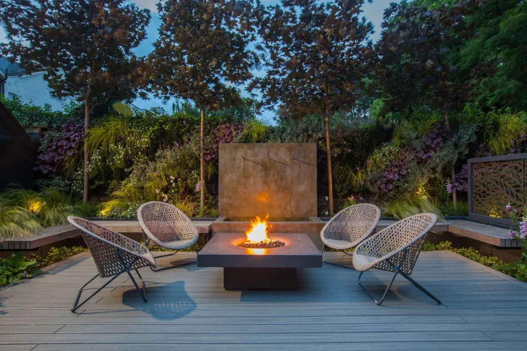 Custom composite deck with lounge chairs around a modern fire pit