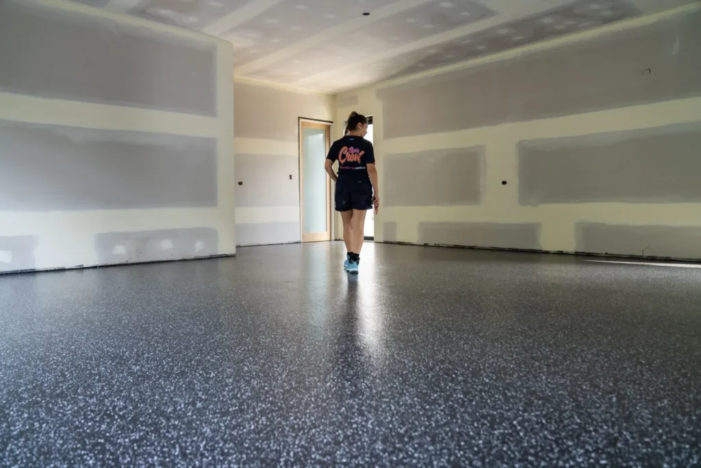 Finished epoxy garage floor with a glossy speckled coating