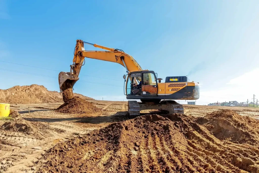 Excavator grading and moving earth on a residential building site