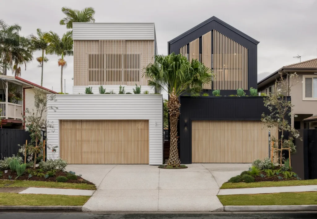 Modern home exterior with a wide double garage door and driveway