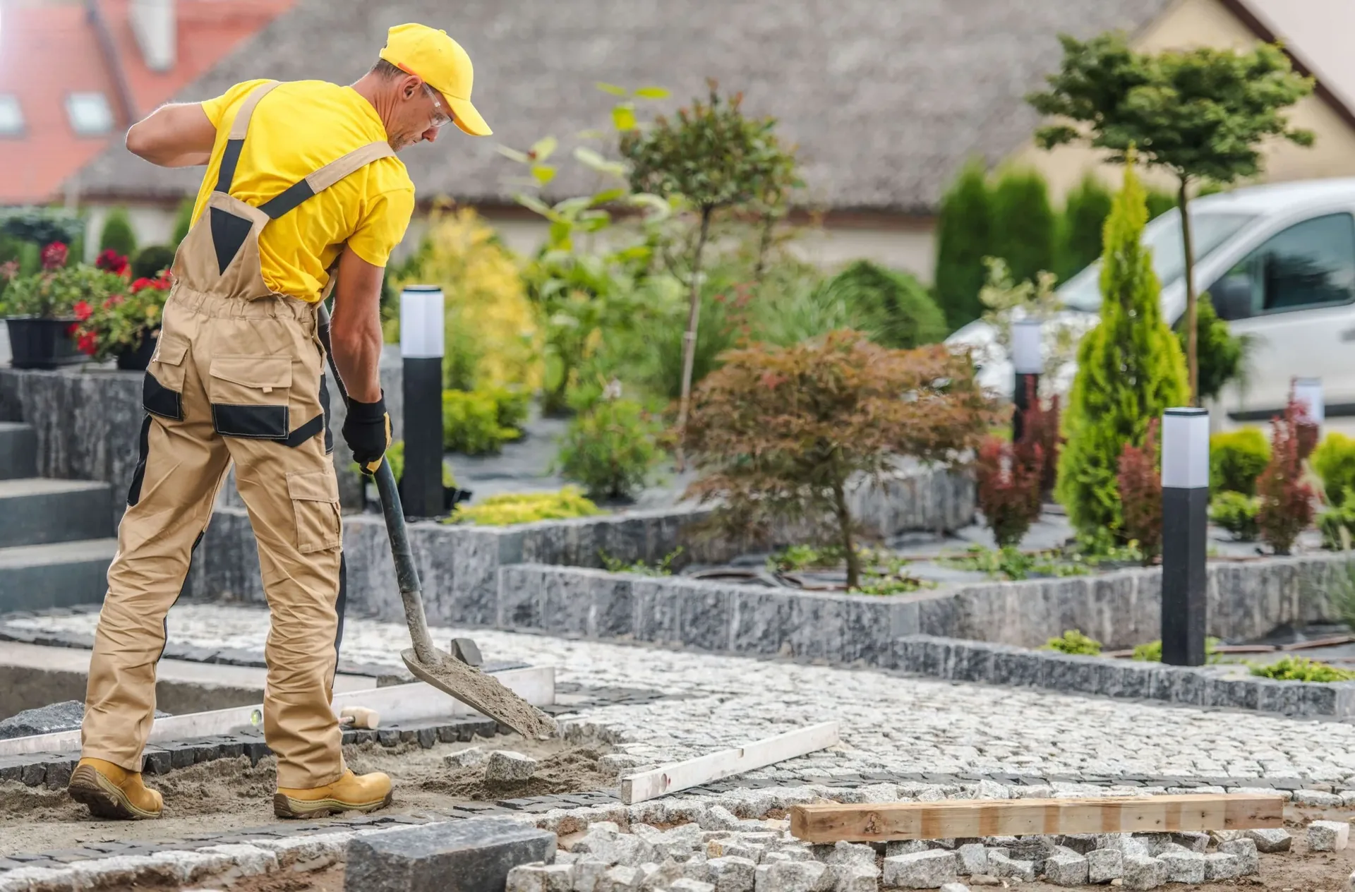 Hardscaping worker preparing and levelling a paver base