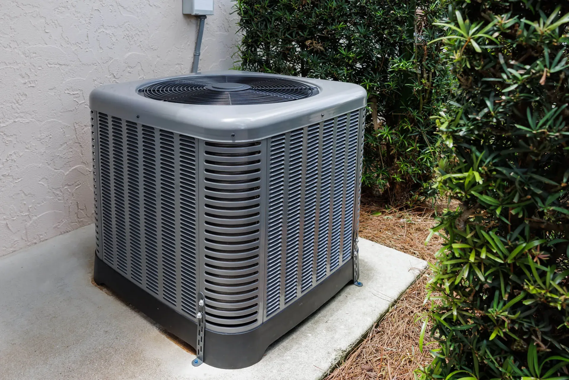 HVAC technician checking refrigerant gauges on a residential air conditioning unit