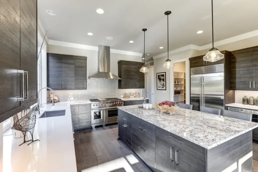 Finished kitchen remodel with a granite island and stainless steel appliances