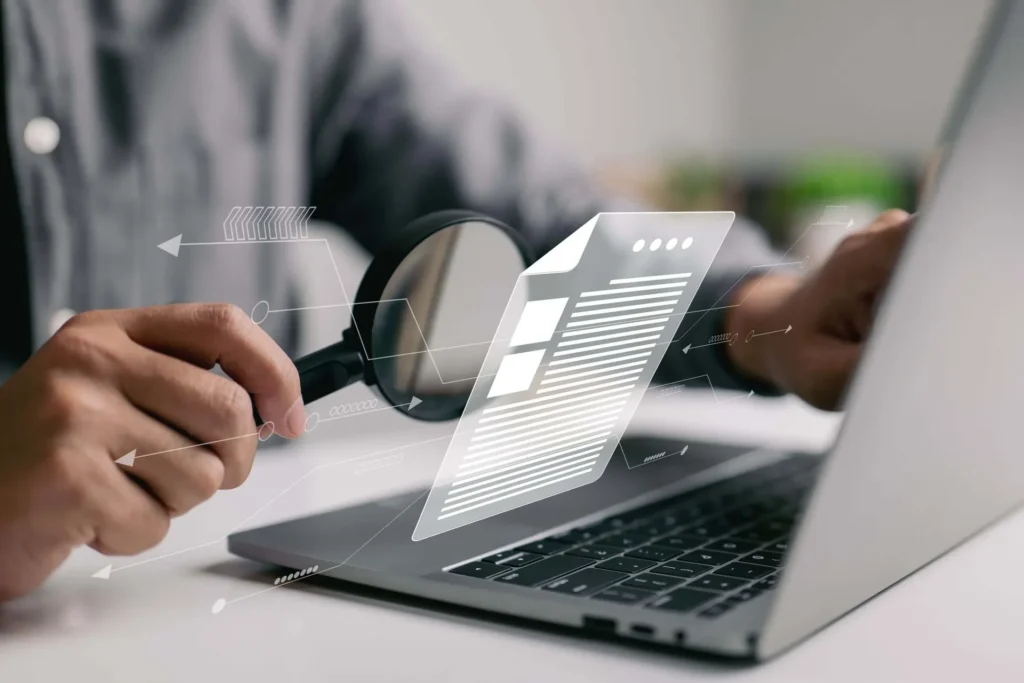 Analyst reviewing website data with a magnifying glass over a report
