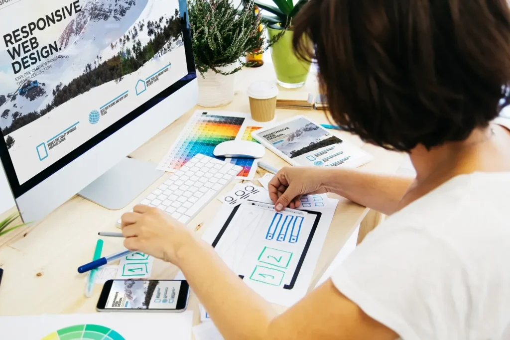 Designer building a small business website at a desktop workstation