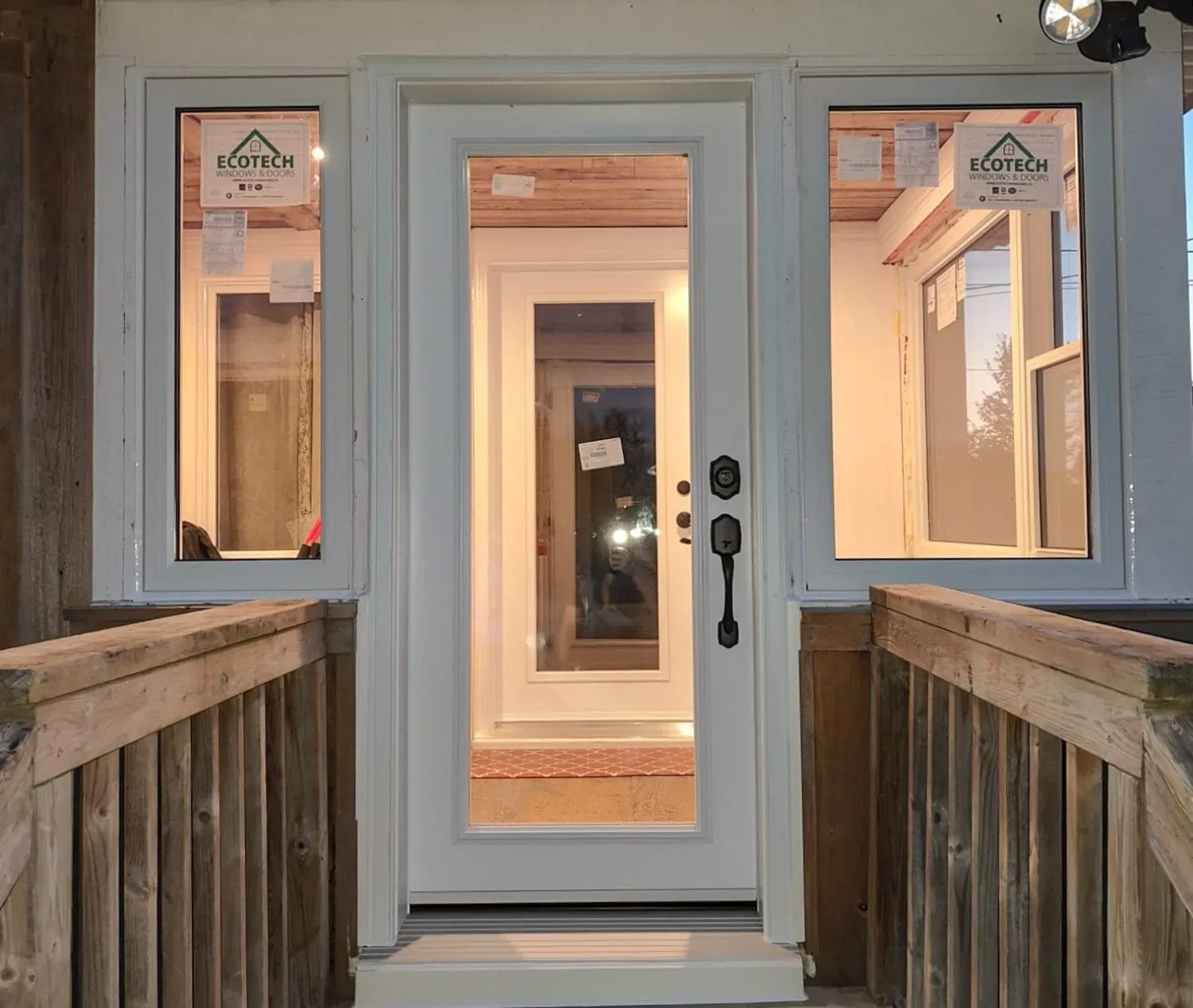 Newly installed modern entry door with sidelight glass panels